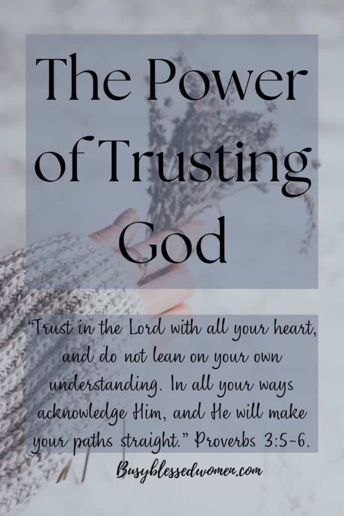 The Power of Trusting God- caucasian woman's arm/hand dressed in ivory sweater holding small sprigs of lavender against a white background 