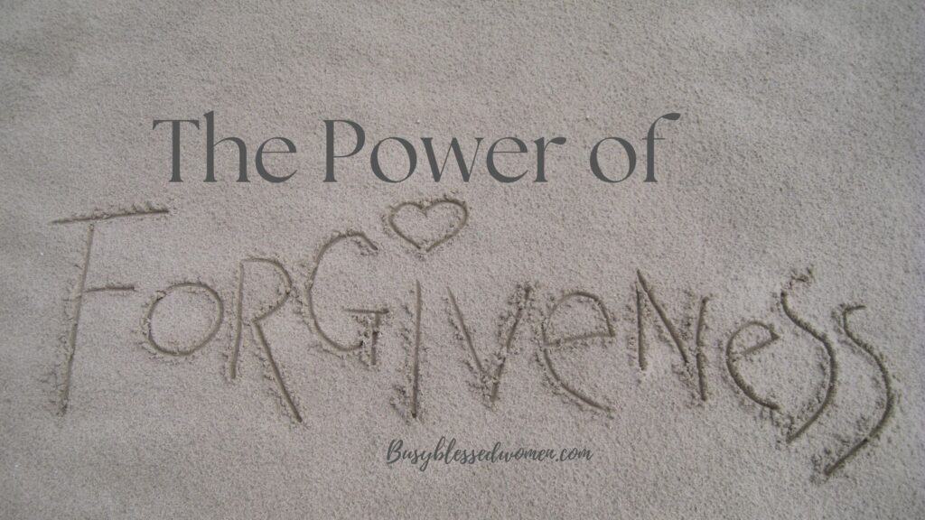 The Power of Forgiveness- the word forgiveness written in the sand -all grey tones of color