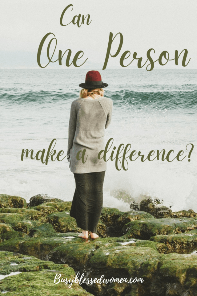 can one person make a difference?- woman with red hat on mossy rocks looking out to sea mossy rock