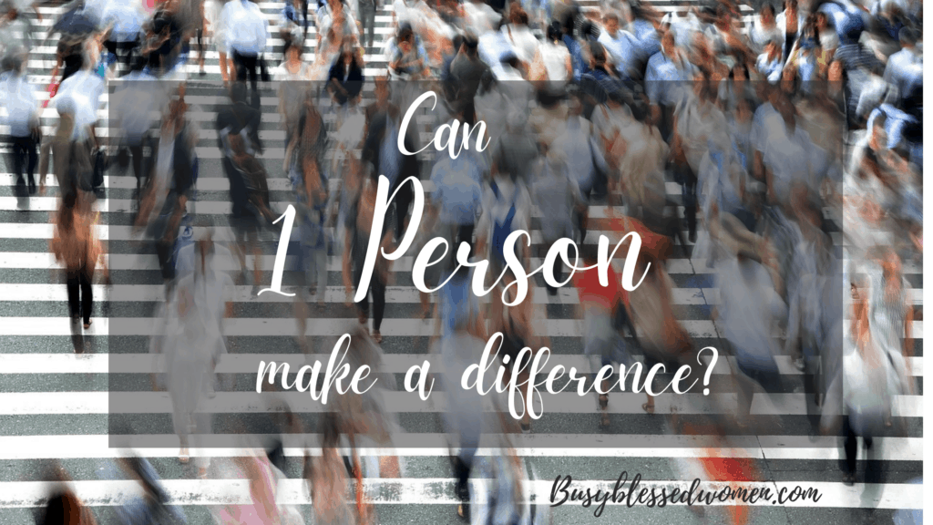 Can one person make a difference- words on blurry busy street scene with many people