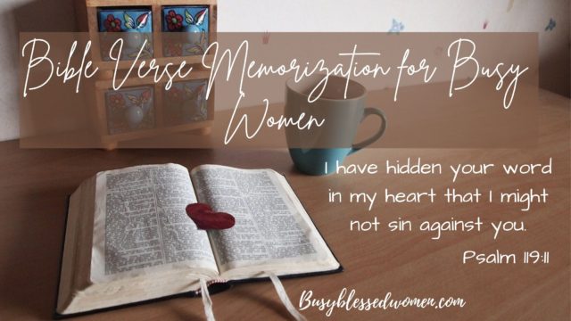 bible verse memorization for busy women- open bible with red heart cut out placed on page; laying on brown table with blue coffee cup and tiny, 4 drawer decorative piece. Psalm 119