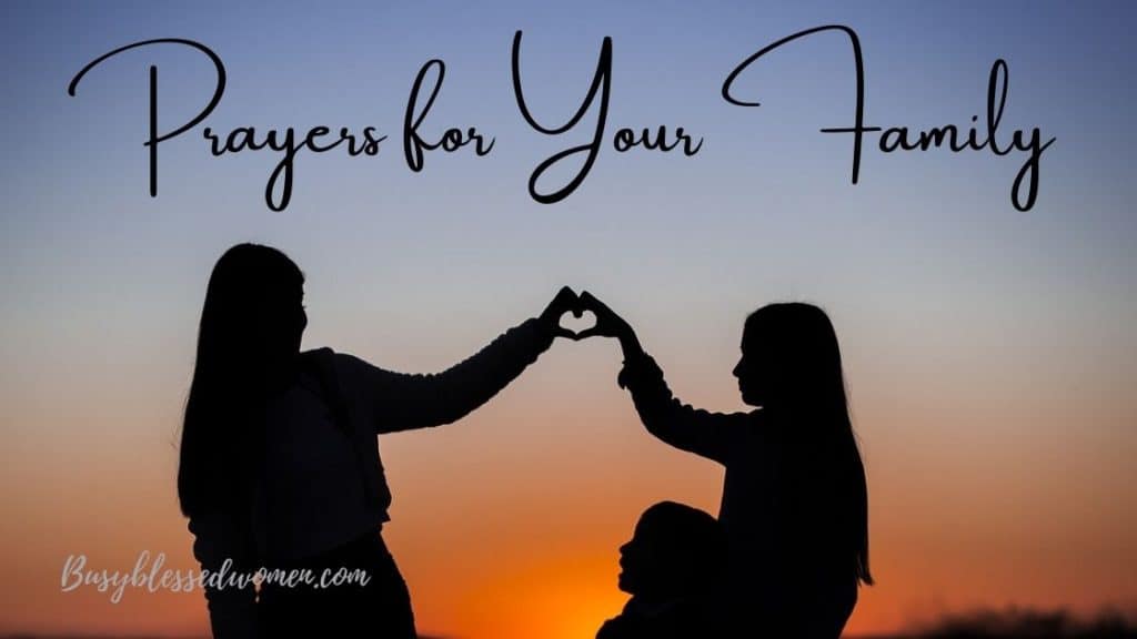 Prayers for your family- two girls making a heart with their hands, young child in lap- sunset sky