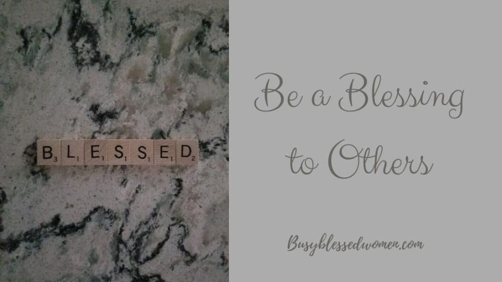 scrabble letters spelling out "blessed" on black/grey swirl marble table