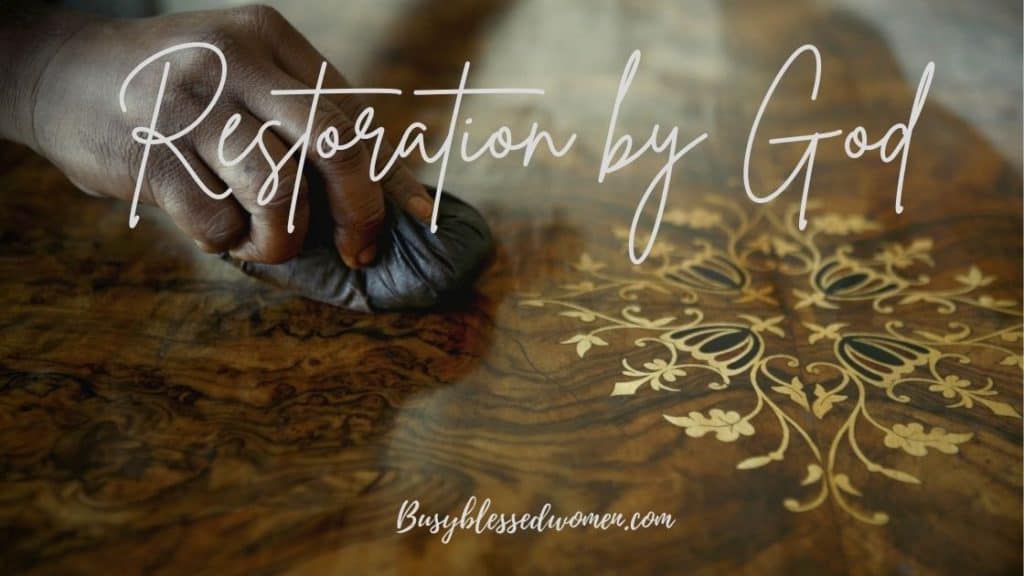 restoration by God- african man polishing antique wooden table with gold insets