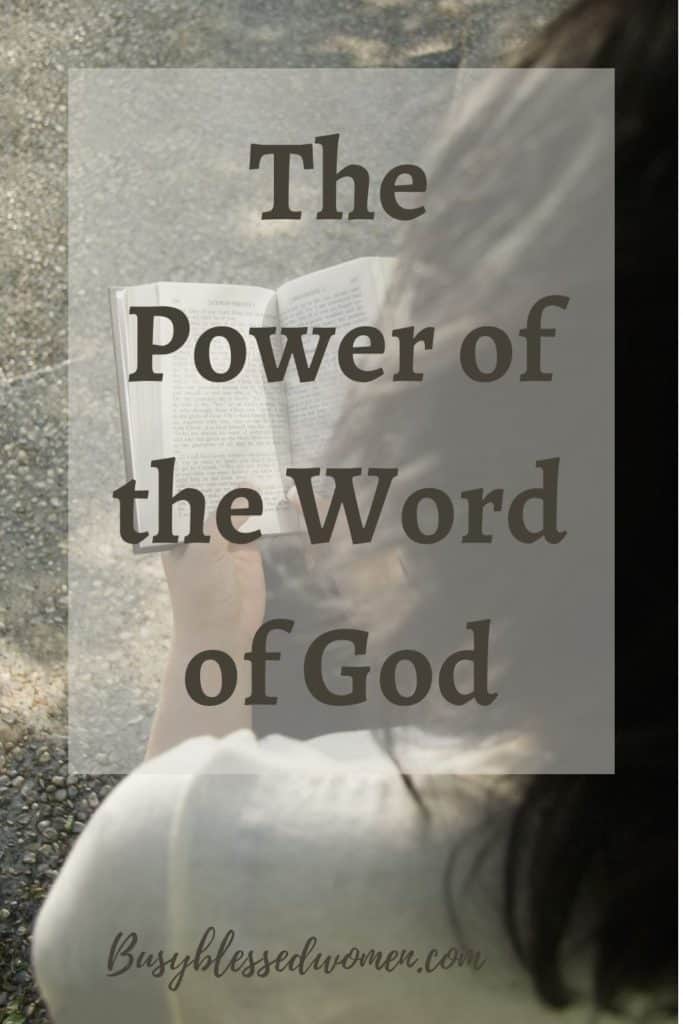 the power of the word of God- view from behind brunette woman in white sweater reading Bible