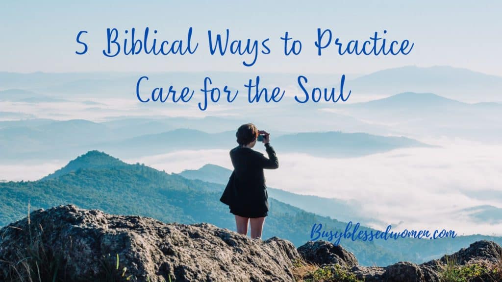 5 Biblical ways to practice care of the soul- woman in black jacket and shorts standing on mountain photographing mountains in front of her.       s