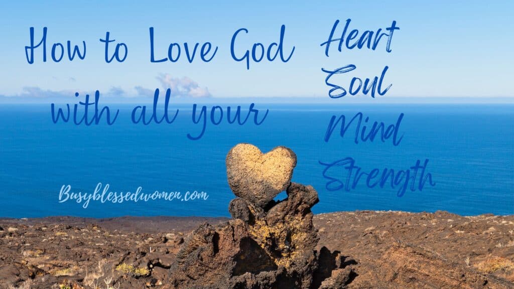 how to love God with all your heart- rocks piled on top of each other on the beach with the top one being heart shaped. Blue ocean and blue sky background