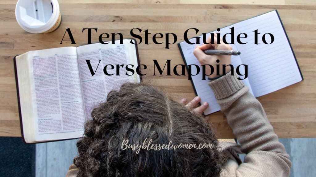 a ten step guide to verse mapping- overhead view of person with dark hair sitting at wooden desk with open bible and beginning to write in notebook