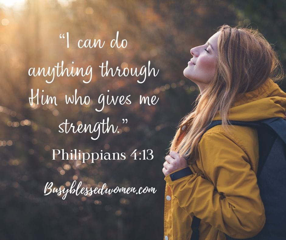 Jesus is our strength- blond woman in yellow parka with dark backpack in forest, eyes closed and smiling with face lifted to sun