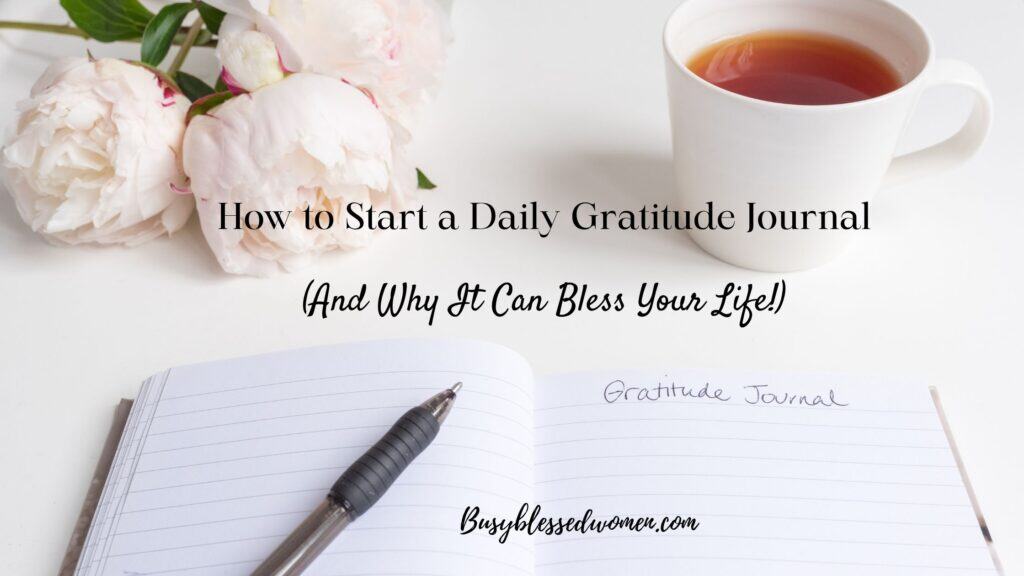 daily gratitude journal- white table with white peonies in upper left, white mug of clear tea upper right, open lined notebook with black pen and words "gratitude journal" written at top
