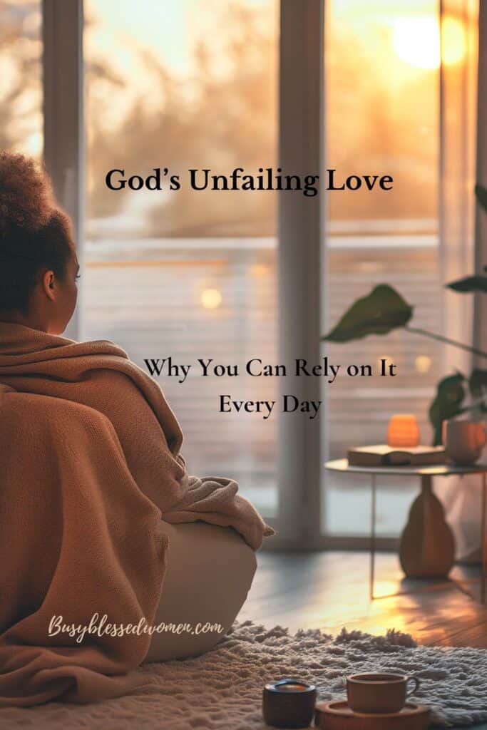 God's Unfailing Love- photo of woman draped in rust colored blanket looking out a window