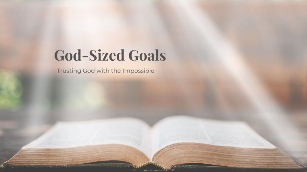 God sized goals- open Bible laying flat with blurry background and light beams shining on it